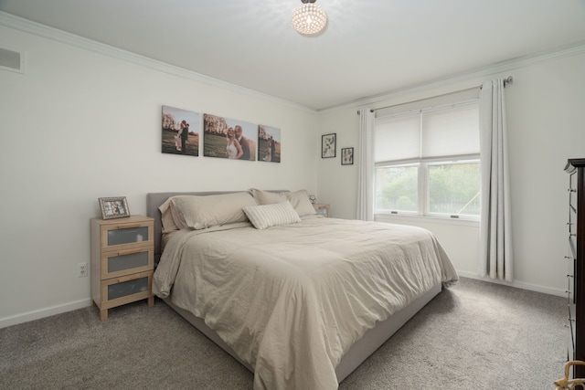 bedroom featuring crown molding, baseboards, visible vents, and carpet