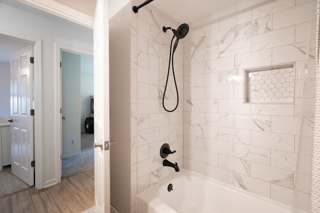 bathroom with bathtub / shower combination and wood finished floors