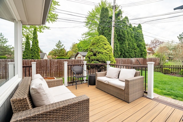 deck with a fenced backyard, a lawn, and an outdoor living space