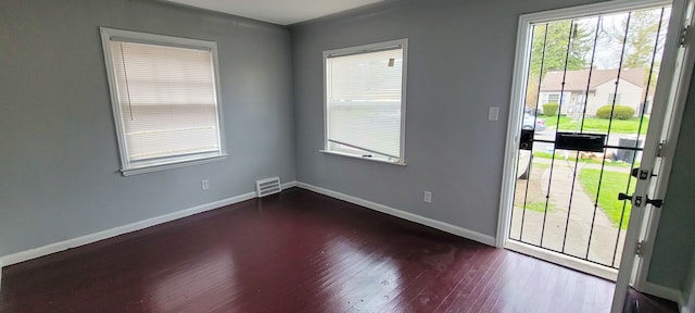 19190 Hoover St, Detroit, MI 48205 - doorway featuring dark wood-style flooring and baseboards
