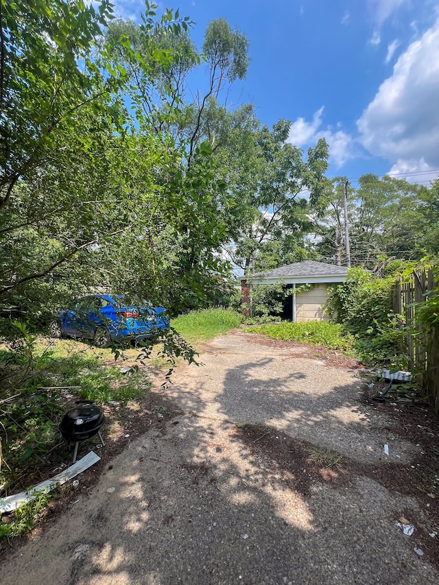 19190 Hoover St, Detroit, MI 48205 - view of yard with fence and dirt driveway