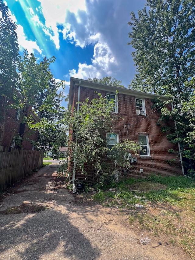 19190 Hoover St, Detroit, MI 48205 - view of side of home featuring fence and brick siding