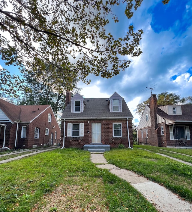 16895 Cruse St, Detroit, MI 48235 - cape cod house featuring brick siding, a front yard, and a chimney