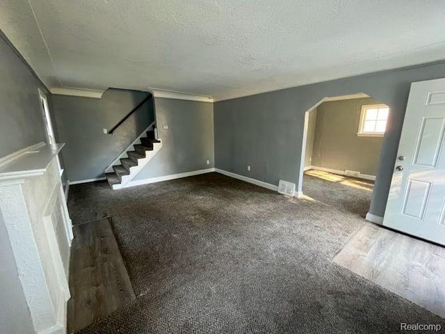 16895 Cruse St, Detroit, MI 48235 - unfurnished living room featuring arched walkways, stairway, a textured ceiling, baseboards, and wood finished floors
