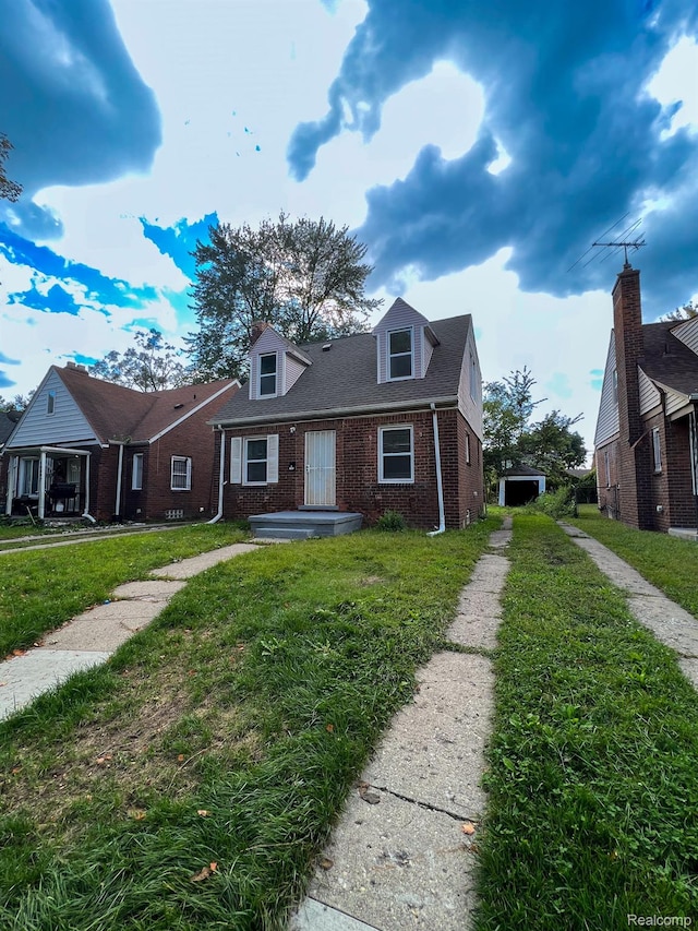 16895 Cruse St, Detroit, MI 48235 - view of front facade featuring brick siding and a front yard