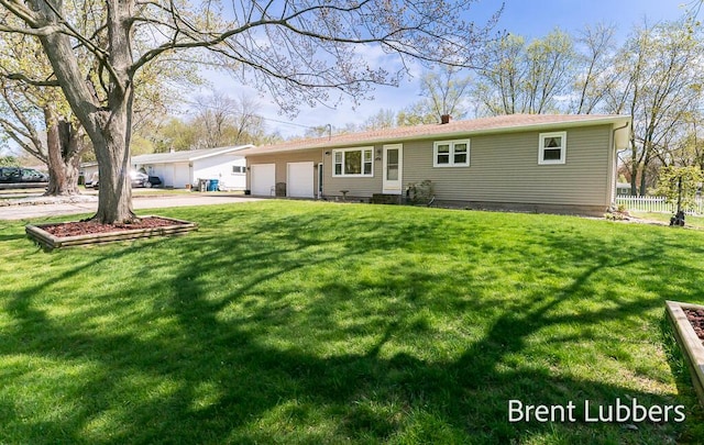 single story home with a garage, fence, concrete driveway, and a front yard