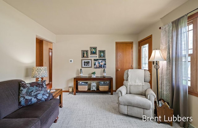 carpeted living room with baseboards