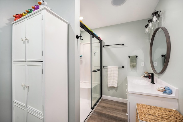 22873 Riverside Dr, Mendon, MI 49072 - bathroom with wood finished floors, a shower stall, vanity, and baseboards