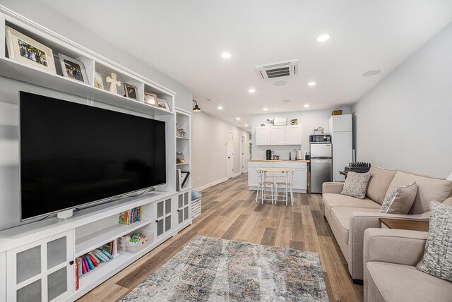 22873 Riverside Dr, Mendon, MI 49072 - living area featuring light wood finished floors, recessed lighting, and baseboards