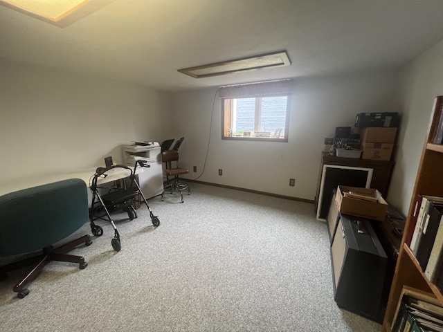 office area with baseboards, attic access, and light colored carpet