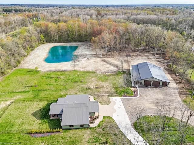 drone / aerial view featuring a wooded view