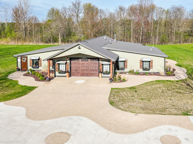 view of front of property featuring concrete driveway, an attached garage, and a front yard