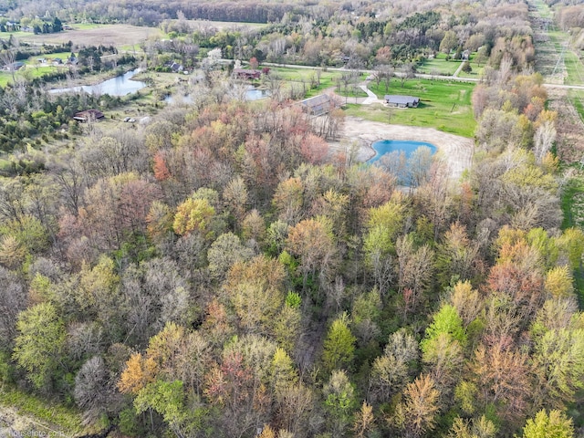 drone / aerial view featuring a water view and a view of trees