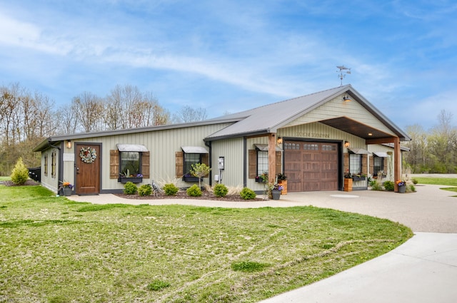 view of front of home with concrete driveway, a front yard, and an attached garage