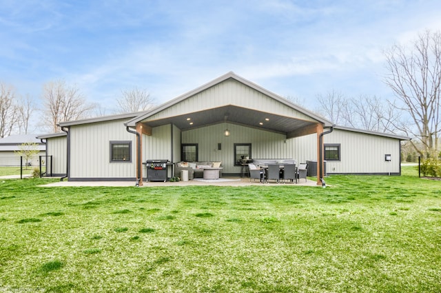 back of house featuring a patio area, outdoor lounge area, and a lawn