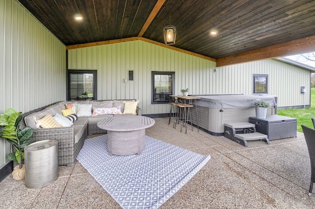 view of patio with a hot tub and an outdoor hangout area