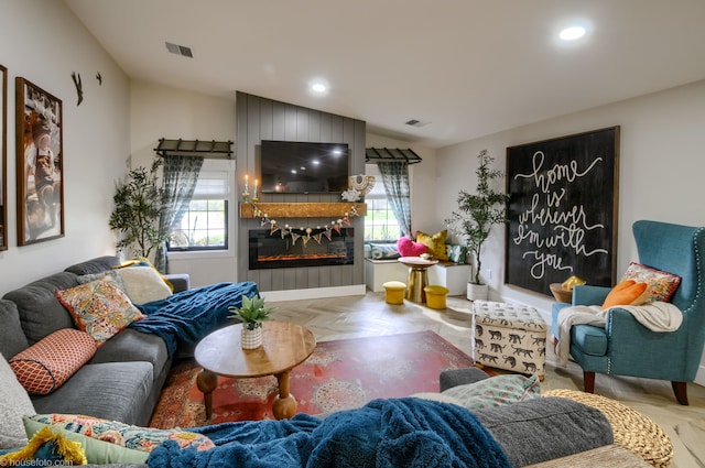 living area with visible vents, a fireplace, lofted ceiling, and recessed lighting