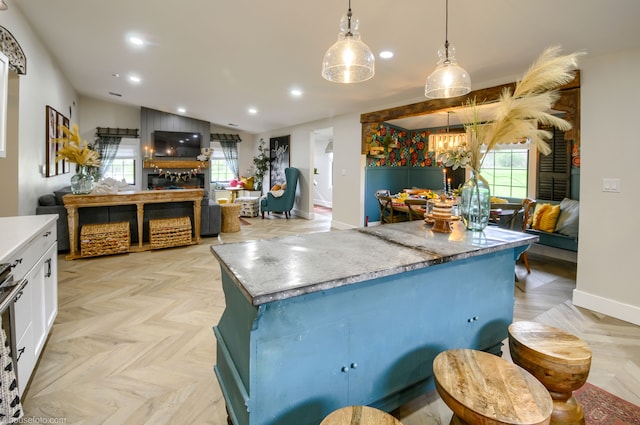 kitchen with decorative light fixtures, white cabinets, recessed lighting, and vaulted ceiling