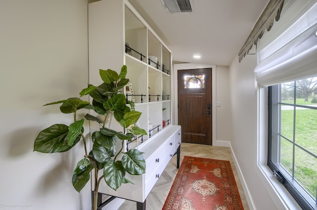 mudroom with baseboards, recessed lighting, a healthy amount of sunlight, and visible vents