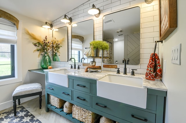 bathroom featuring a wealth of natural light, visible vents, and a sink
