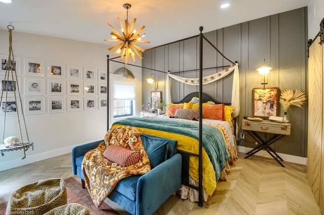 bedroom featuring baseboards, a barn door, an inviting chandelier, and recessed lighting
