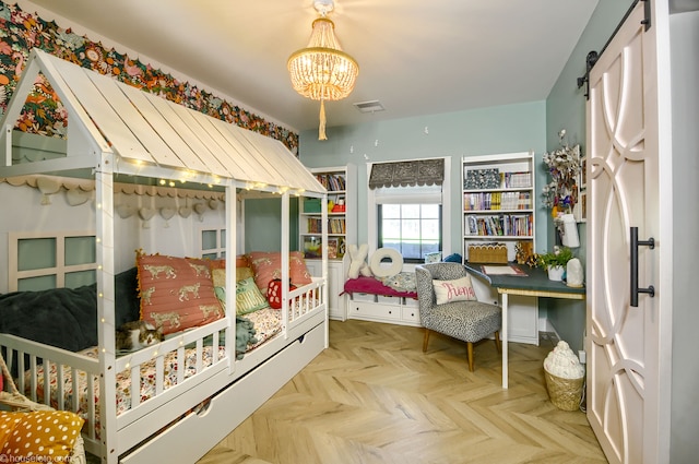 bedroom with an inviting chandelier, visible vents, and a barn door