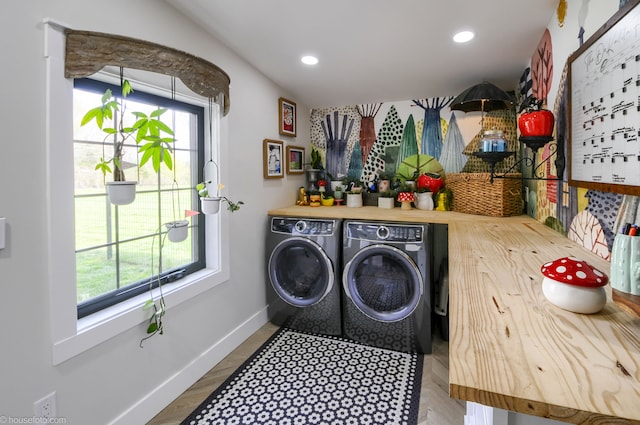 laundry area with wood finished floors, laundry area, recessed lighting, washing machine and dryer, and baseboards