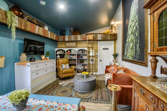 sitting room featuring lofted ceiling and wood finished floors