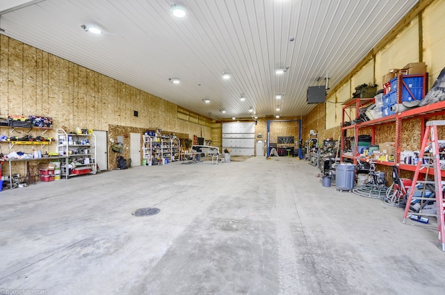 garage with a workshop area and recessed lighting