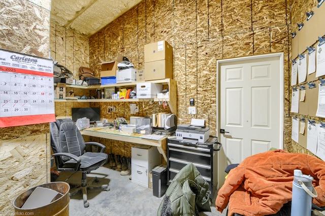 home office featuring concrete flooring