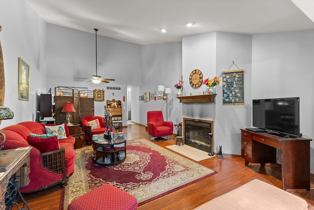 26901 Ann Arbor Trl, Dearborn Heights, MI 48127 - living room with a fireplace with flush hearth, a ceiling fan, wood finished floors, recessed lighting, and lofted ceiling