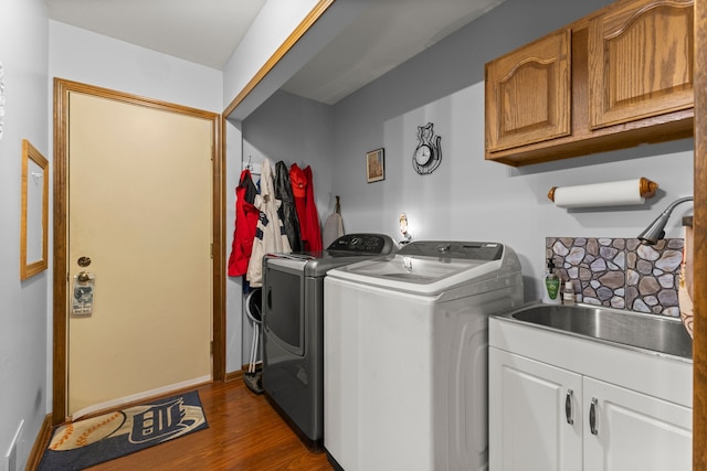 26901 Ann Arbor Trl, Dearborn Heights, MI 48127 - clothes washing area with washing machine and dryer, cabinet space, dark wood-style floors, and baseboards