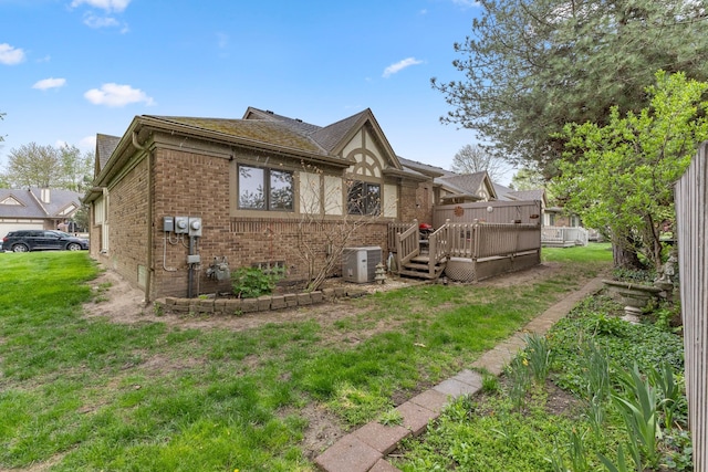 26901 Ann Arbor Trl, Dearborn Heights, MI 48127 - rear view of property featuring brick siding, a yard, a deck, and central air condition unit