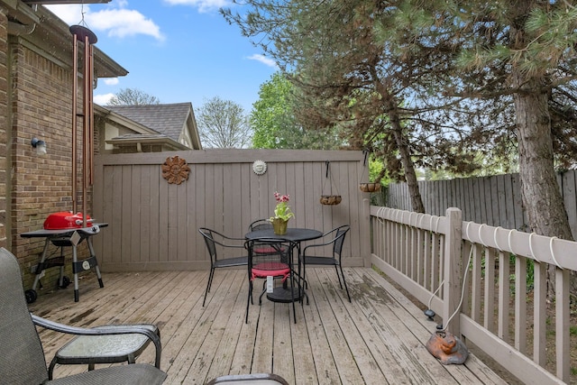 26901 Ann Arbor Trl, Dearborn Heights, MI 48127 - deck featuring outdoor dining area, a fenced backyard, and grilling area