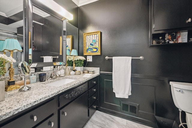 bathroom with crown molding, vanity, toilet, marble finish floor, and visible vents
