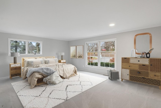 carpeted bedroom featuring baseboards, multiple windows, and recessed lighting