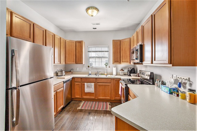 7200 Addington Dr, Commerce Twp, MI 48390 - kitchen with light countertops, stainless steel appliances, visible vents, and a sink