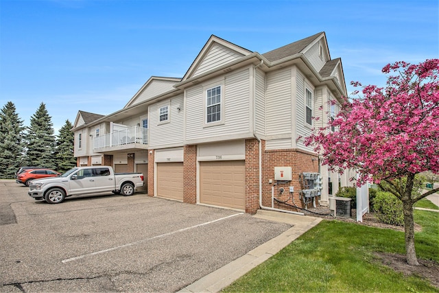 7200 Addington Dr, Commerce Twp, MI 48390 - exterior space featuring central air condition unit, aphalt driveway, a garage, and brick siding