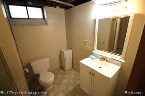 bathroom with vanity, toilet, and radiator