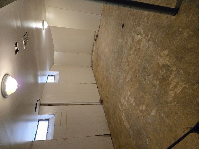 empty room featuring concrete block wall and a wealth of natural light