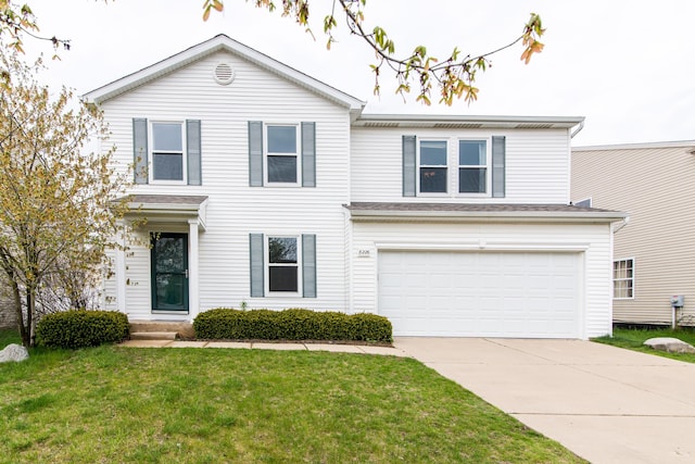 traditional-style house featuring an attached garage, a front yard, and concrete driveway