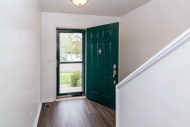 foyer with visible vents, dark wood finished floors, and baseboards