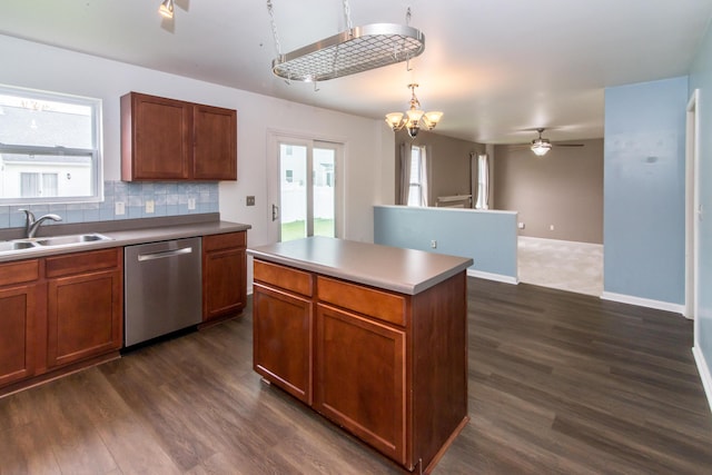 kitchen with a sink, dishwasher, ceiling fan with notable chandelier, tasteful backsplash, and dark wood-style floors