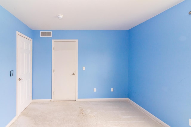 unfurnished bedroom featuring carpet flooring, baseboards, and visible vents