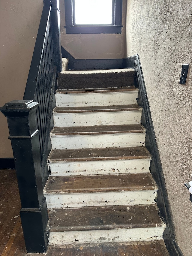 stairway featuring wood finished floors