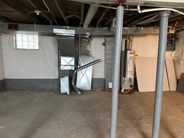 below grade area featuring visible vents, water heater, and electric panel