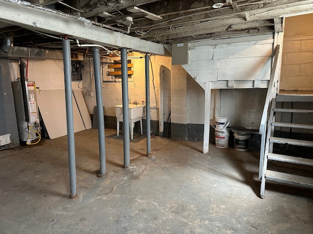 unfinished basement with water heater and a sink