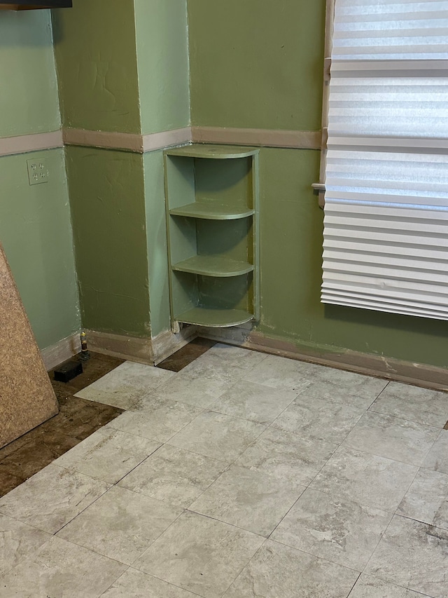 interior space featuring baseboards