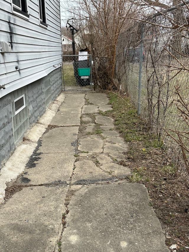 exterior space with driveway and a gate