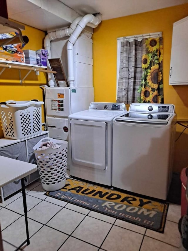 18664 Bradstreet Rd, Hudson, MI 49247 - laundry room featuring cabinet space, light tile patterned floors, and washer and dryer